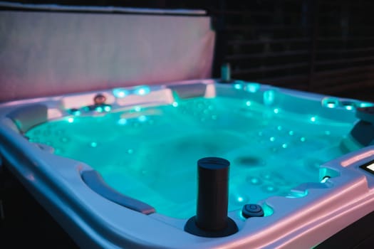 self-contained hot tub or pool with hot water and evening lighting.