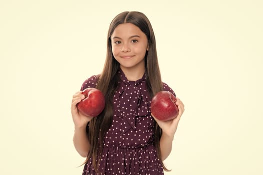 Teenager child with apple on yellow isolated background. apples are good for children. Portrait of happy smiling teenage child girl