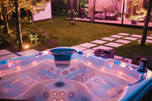 self-contained hot tub or pool with hot water and evening lighting.