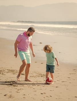 small kid and dad running on beach in summer vacation with ball, parenting.
