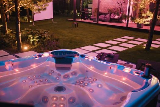 self-contained hot tub or pool with hot water and evening lighting.