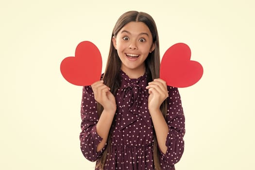 Happiness kids and love concept. Romantic lovely teen girl with red heart, world heart day, happy valentines day. Portrait of emotional amazed excited teen girl