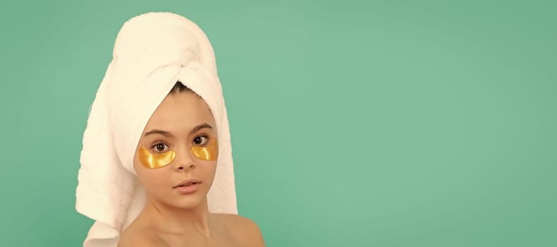 Close up face of kid girl, facial treatment, teen kid in shower towel with golden patch. Cosmetics and skin care for teenager child, poster design. Beauty kid girl banner with copy space