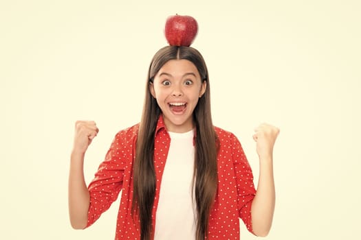 Portrait of confident teen girl with apple going to have healthy snack. Health, nutrition, dieting and kids vitamins. Portrait of emotional amazed excited teen girl