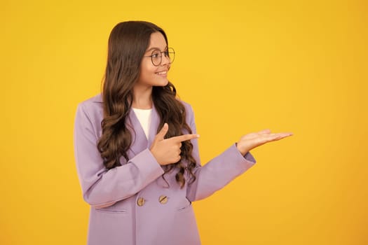 Close-up portrait of her she nice cute attractive cheerful amazed girl pointing aside on copy space isolated on yellow background. Mock up copyspace