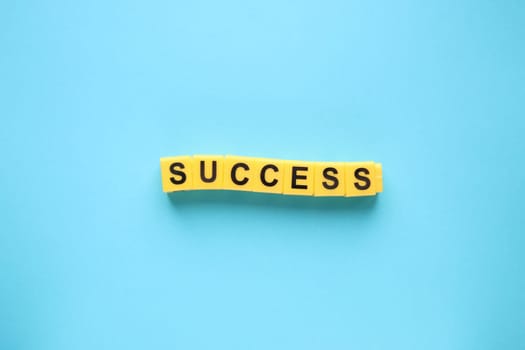 Success creative concept. Lettering from yellow cubes.