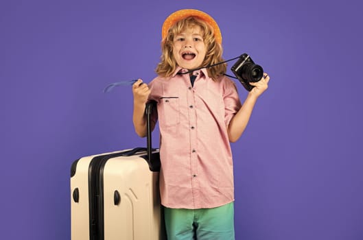 Child travel with travel bag. Child with suitcase dreams of travel, adventure, vacation. Studio kids portrait