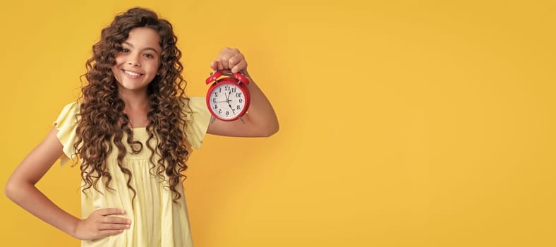 cheerful child with alarm clock. school kid curly hair showing clock. you are late. deadline. Teenager child with clock alarm, horizontal poster. Banner header, copy space