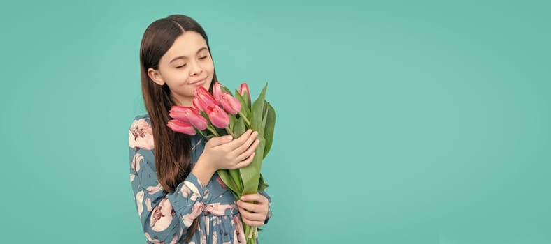 floral present. happy child smell tulips. mothers or womens day. Banner of spring child girl with tulips flowers bouquet, studio portrait with copy space