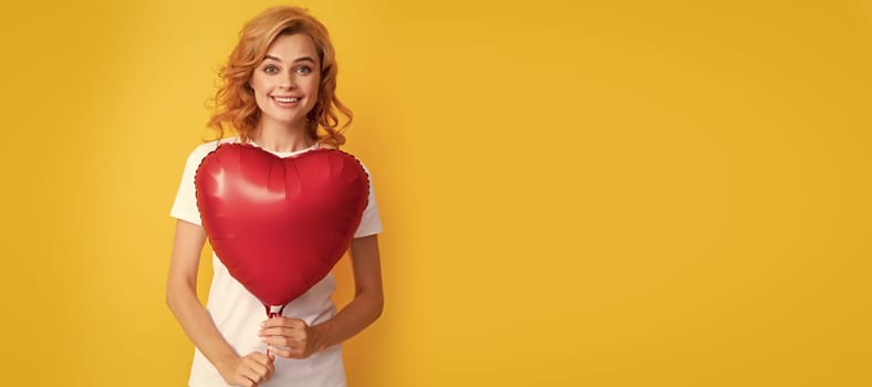 happy redhead girl with love heart balloon. charity and donation. Beautiful woman isolated face portrait, banner with mock up copy space