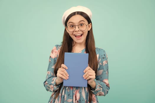 Teen girl pupil hold books, notebooks, isolated on blue background, copy space. Back to school, teenage lifestyle, education and knowledge. Excited teenager, amazed and cheerful emotions