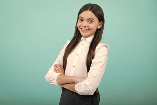 Cute little teenager girl crossing arms over yellow background