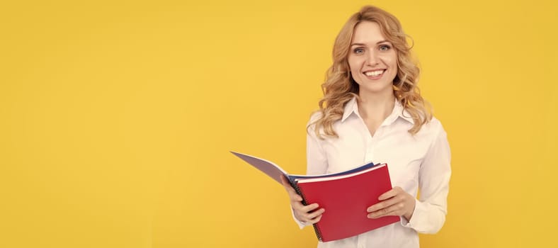 happy blonde businesswoman woman in white shirt making notes in notepad or notebook, education. Woman isolated face portrait, banner with mock up copy space