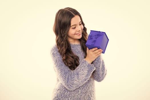 Teen with gift, celebrating teenagers birthday. Excited funny kid child girl holding gift box celebrating happy New Year isolated on white background. Merry Christmas presents shopping sale