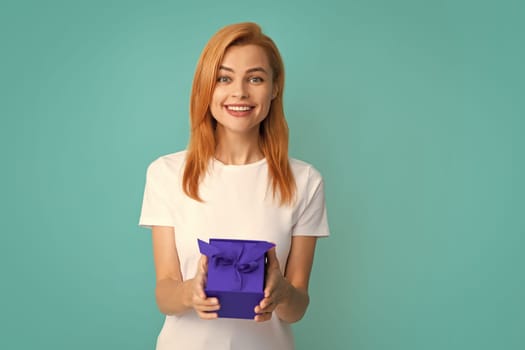 Beautiful girl holding valentines gift. Happy birthday celebration, woman day, christmas. Woman holding gift box and rejoices