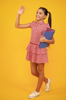Teenager school girl with books isolated studio background. Happy teenager, positive and smiling emotions of teen girl