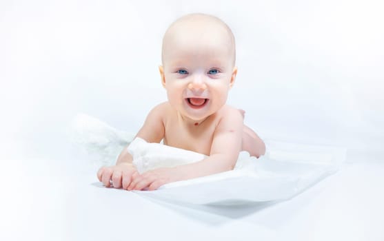 a baby with a hemangioma on his neck lies on a white background. banner with a copy space. profile of a little bald baby girl. the kid looks to the side