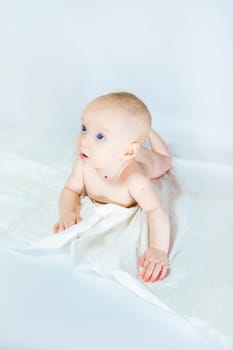 a baby with a hemangioma on his neck lies on a white background. banner with a copy space. profile of a little bald baby girl. the kid looks to the side