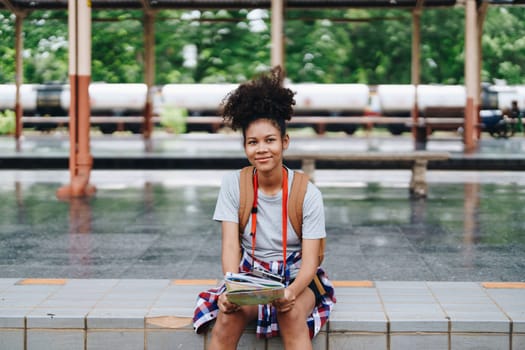 Asian teenage girl african american traveler dressed in casual wear holding map and searching right direction of route