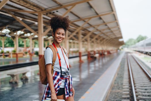 Asian teenage girl african american traveler dressed in casual wear holding map and searching right direction of route