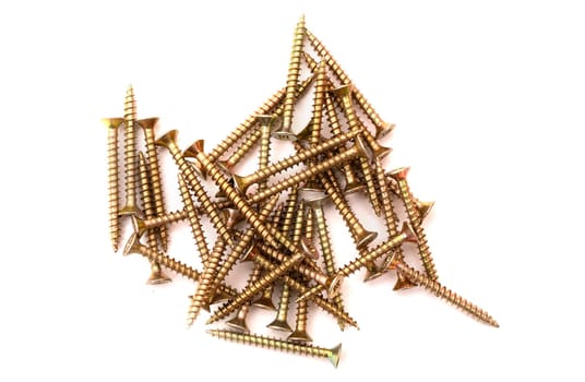 Pile of yellow self-tapping screws on a white background.