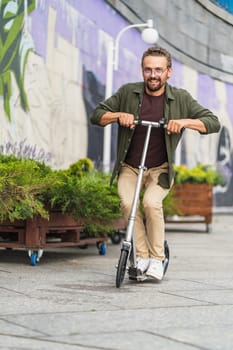 Man on a scooter performing stunts with a big wheel scooter. With a handsome and confident appearance, he showcases his skills and has a blast while engaging in thrilling maneuvers. High quality photo