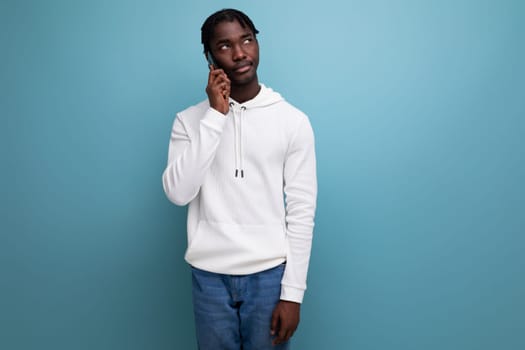 inspired charming man young brunette african man on blue isolated background.