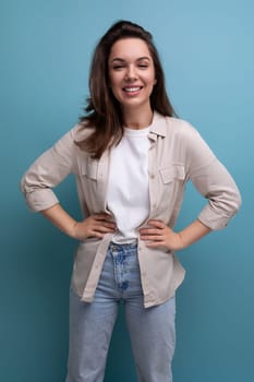 romantic charming brunette 30 year old female person dressed in a shirt and jeans on a studio background.