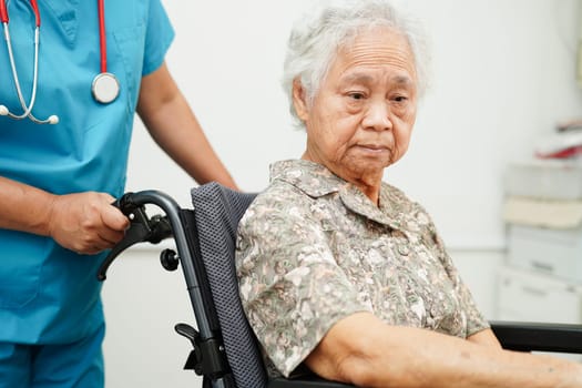 Doctor help Asian elderly woman disability patient sitting on wheelchair in hospital, medical concept.