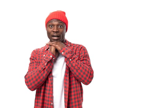 young african man in shirt in red plaid shirt over isolated white background.