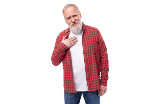 pleasant satisfied 60 year old gray-haired pensioner man with a beard and mustache in a casual look.