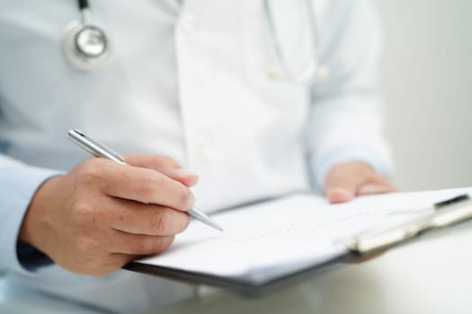 Doctor checking and note diagnosis medicine in clipboard of patients in hospital.