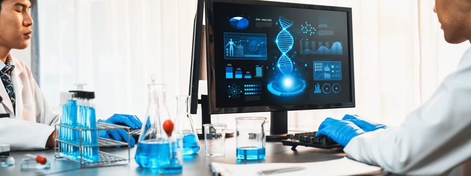 Dedicated scientist group working on advance biotechnology computer software to study or analyze DNA data after making scientific breakthrough from chemical experiment on medical laboratory. Neoteric