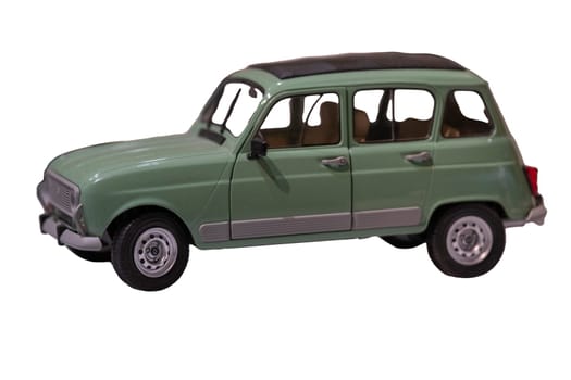 A scale model of a mint pastel green vintage car from 1950-60s. Car is a 4 door station wagon and has a roll off leather or canvas top. Isolated on white with clipping path. Focus on foreground