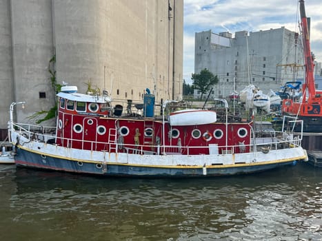 MILWAUKEE, WISCONSIN - JULY 14, 2022: Barge in the Milwaukee River in the middle of summer . High quality photo