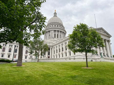 Madison Wisconsin State Capitol building with green grass and trees in the background. High quality photo
