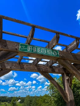 uff-da beaten path - Funny street sign under a bridge with sunny background . High quality photo