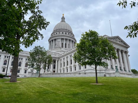 Madison Wisconsin State Capitol building with green grass and trees in the background. High quality photo