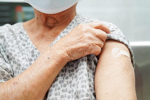 Asian elder senior woman getting vaccine for protect corona virus.