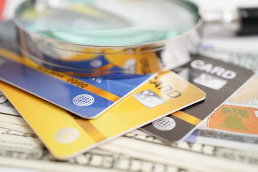 Credit card and magnifying glass for online shopping, security finance business concept.