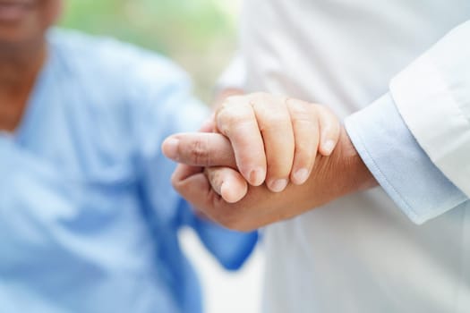 Doctor holding hands Asian elderly woman patient, help and care in hospital.