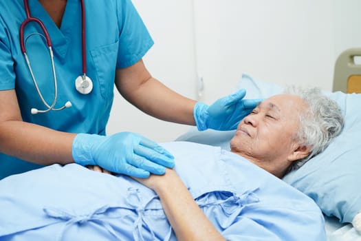 Doctor taking care, help and encourage Asian elder senior woman patient in clinic hospital.