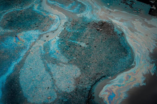 Gasoline on wet pavement leaves a big stain. Environmental pollution concept