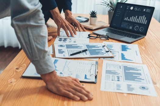 Busy analyst team in office analyzing financial data analysis for marketing strategy in workspace using BI dashboard with graph and chart on laptop screen to improve business performance. Entity