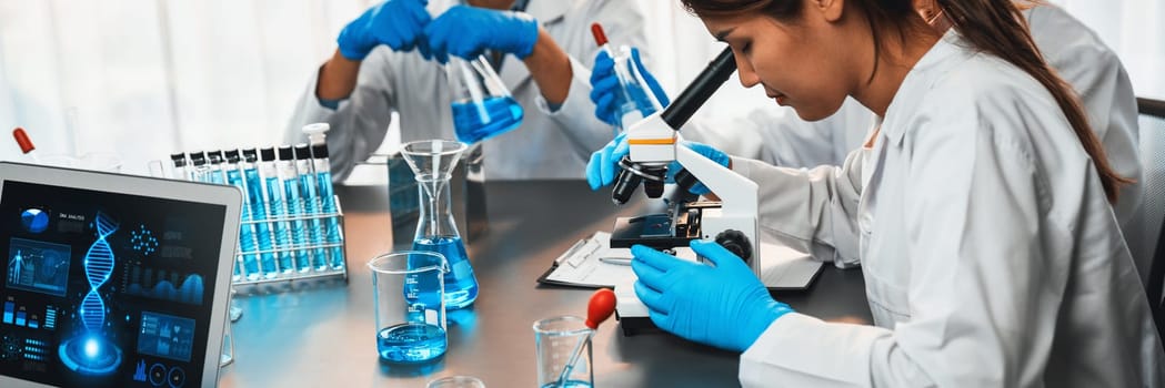 Dedicated scientist group working on advance biotechnology computer software to study or analyze DNA data after making scientific breakthrough from chemical experiment on medical laboratory. Neoteric