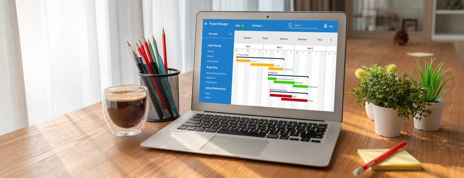 Project planning software for modish business project management on the computer screen showing timeline chart of the team project