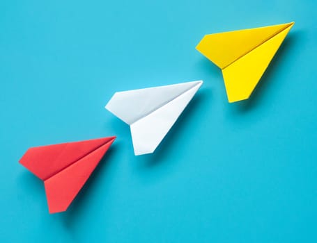 Top view of red, white and yellow paper on blue background with customizable space for text.
