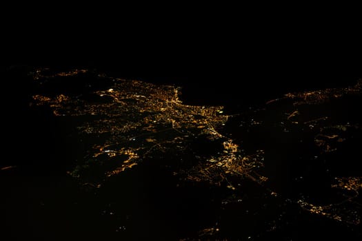 Take in the illuminated coastal city of Saint Raphael, France from above, with stunning light displays and a view of the city at night.