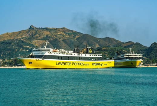 Mare di Levante and Fior Di Levante Ferries car passenger boats with distinctive colors and logo on a calm sea in the Ionian Islands.