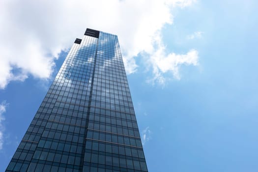 Downtown, Glass Skyscraper Or Tower and Blue Shiny Sky on Background. Business Development Or Financial Center concept. Copy Space on Right. Horizontal Plane. Modern Building. High quality photo